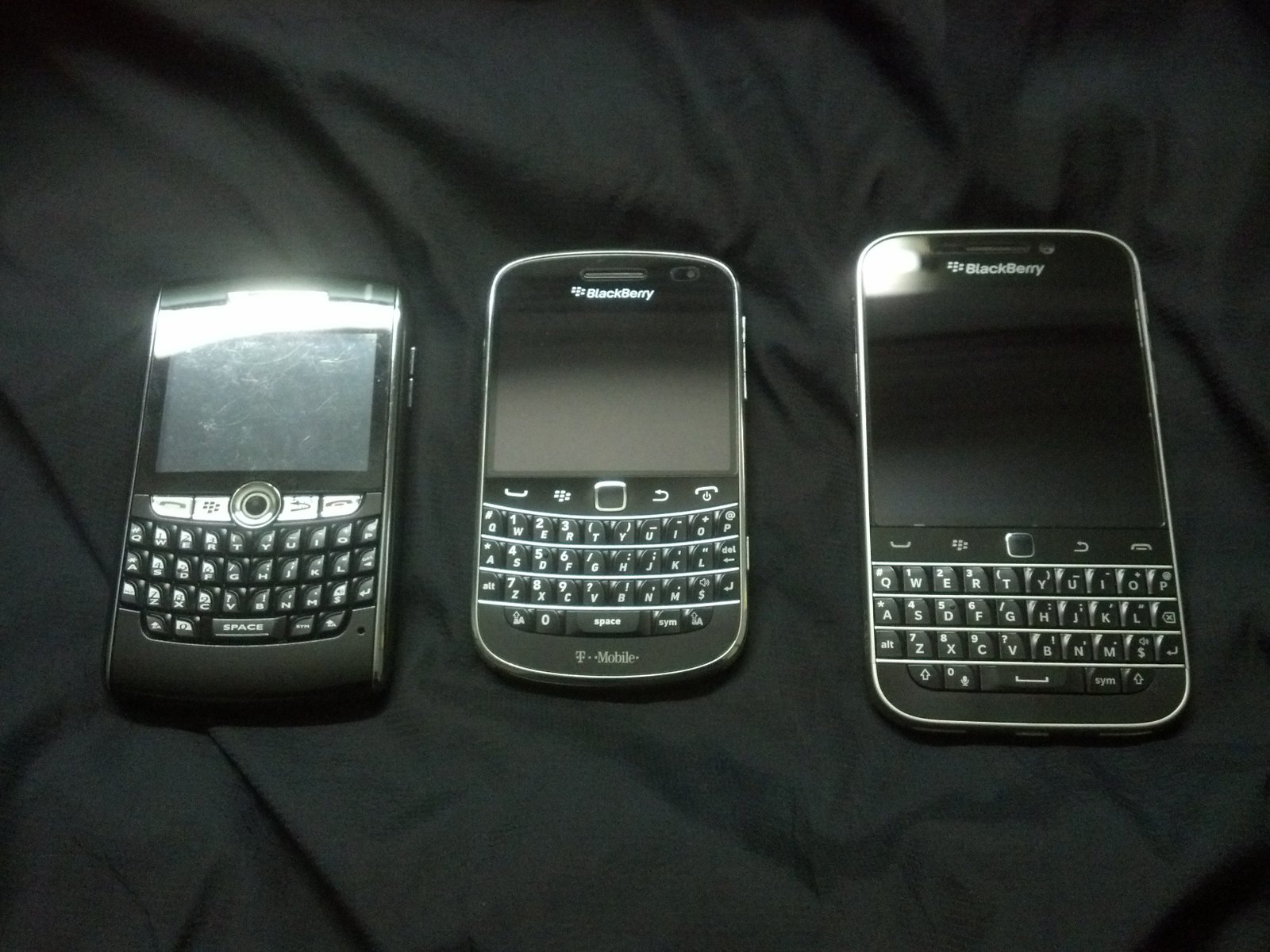 Three generations of BlackBerry devices: 8820, Bold 9900 and Classic